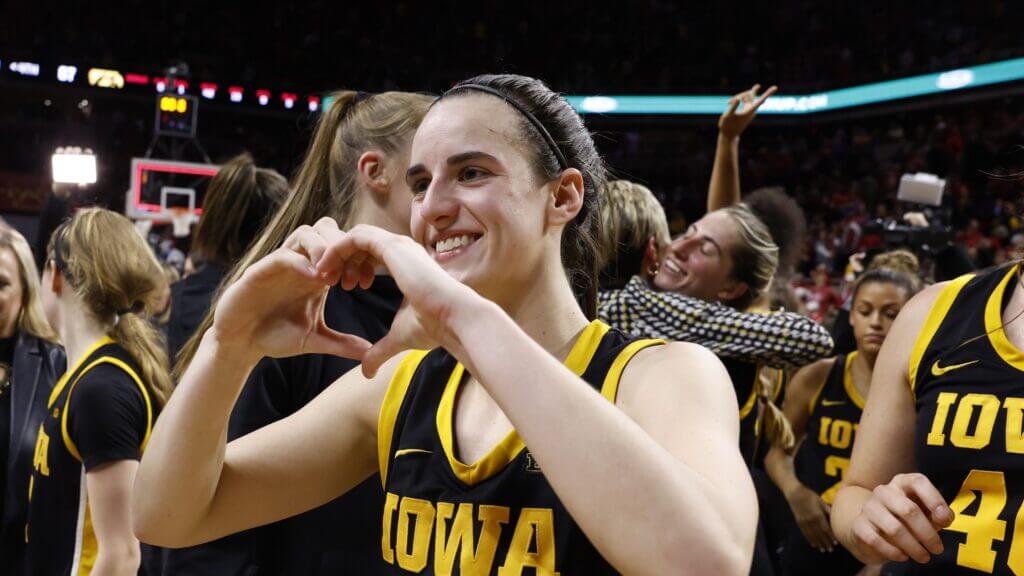 Caitlin Clark making a heart sign with her hands